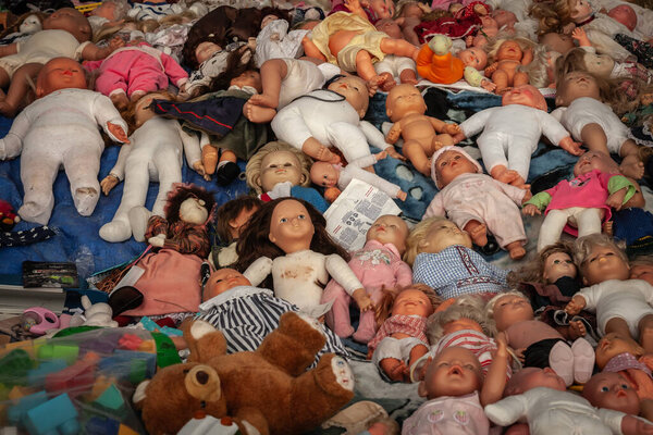 OBRENOVAC, SERBIA - JULY 12, 2025: Assorted second hand toys at a market in Obrenovac. A blanket covered with dolls, plush figures in mixed condition, illustrating secondhand resale, low cost buying .