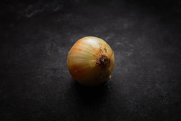 Cebolla Cruda Con Piel Descamada Sobre Hormigón Oscuro — Foto de Stock