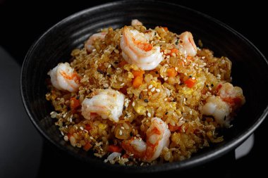 Koyu arkaplanda karides ve susamlı kızarmış pirinç. Panasia