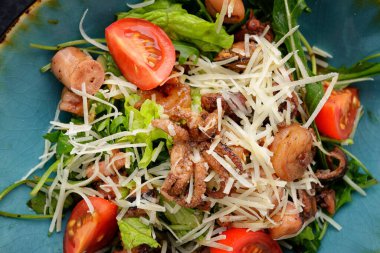 Seafood salad, octopus, shrimp, scallops with cheese and tomatoes