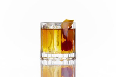 alcoholic cocktail of yellow color with a cherry, in an old-fashioned glass, on a white background