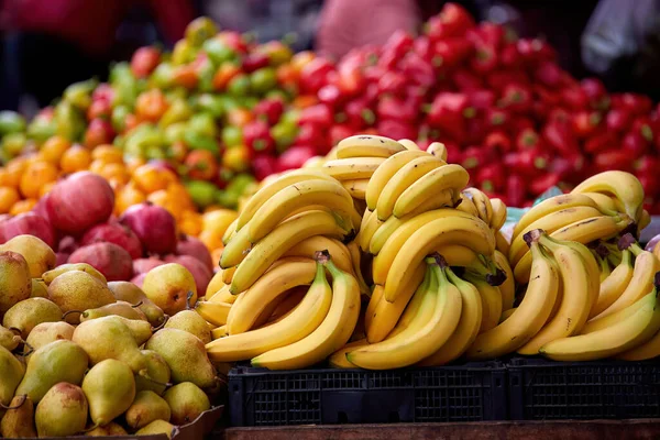 stock image bananas among other vegetables and fruits, at the market, with a blurred background