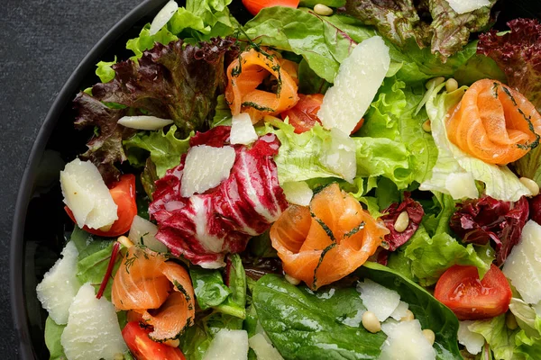 stock image Salad with salmon and Parmesan cheese, in a plate, close-up