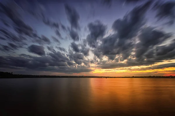 stock image Long exposure sunrise over the river. Blurred clouds and water