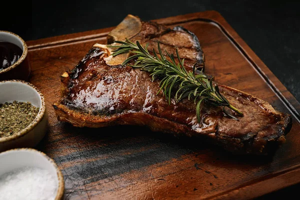 Bone Steak Grilled Perfection Rosemary Spices Dark Wooden Board — Stock Photo, Image
