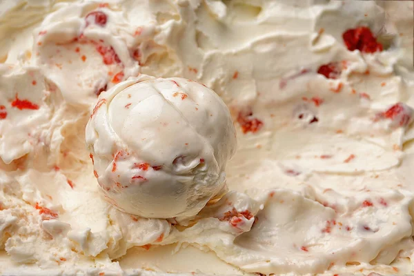 stock image A scoop of ice cream filling with a cherry close-up on a background of ice cream filling