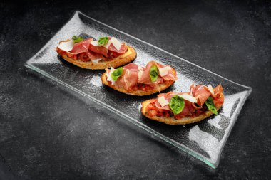 Kızarmış bruschetta üzerine parmesan peyniri ve füme somon.