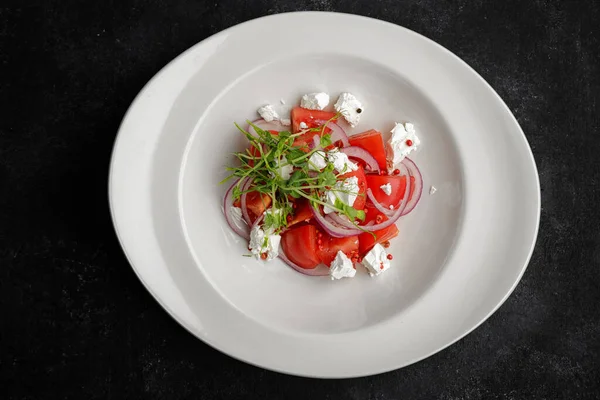 Stock image colorful spring salad with ripe tomatoes, feta cheese, onions, and microgreens