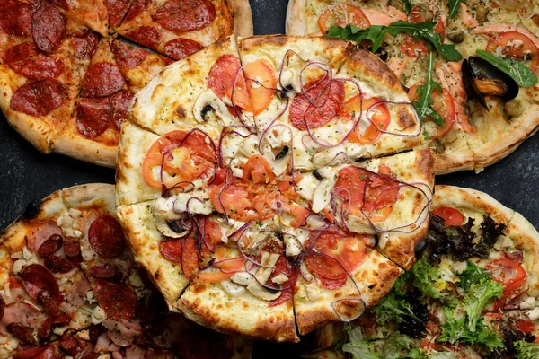 Five different types of pizza with different toppings