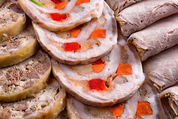 Sliced roast meat and meat rolls in assortment, close-up