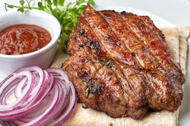 Soğanlı ve soslu ızgara biftek.