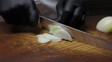 Profesyonel şef soğanları ince ince doğrar ve sıcak tavada erimiş tereyağında kızartırdı.