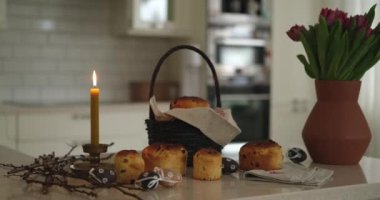 Easter cakes on the background of basket with embroidered towel and burning candle. Ukrainian style High quality photo