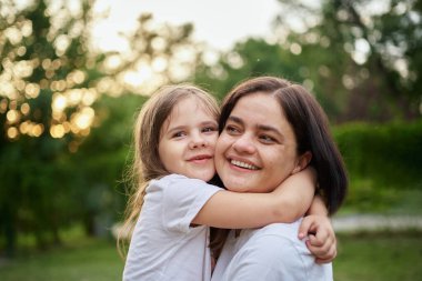 happy harmonious family outdoors. mother throws baby up, laughing and playing in the summer on the nature. High quality photo
