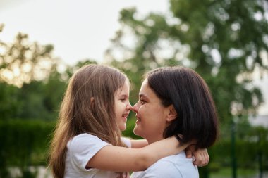 happy harmonious family outdoors. mother throws baby up, laughing and playing in the summer on the nature. High quality photo