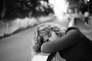 Beyaz, olgun, güzel bir kadının yakın plan portresi. Parkta güneşe bakıyor. Gün batımından saklanıyor. Yüksek kalite fotoğraf