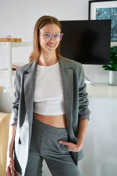 stock image Young female in the glasses and grey suit smiling in the office background. Hr or CEO woman, layer, maybe real estate. High quality photo