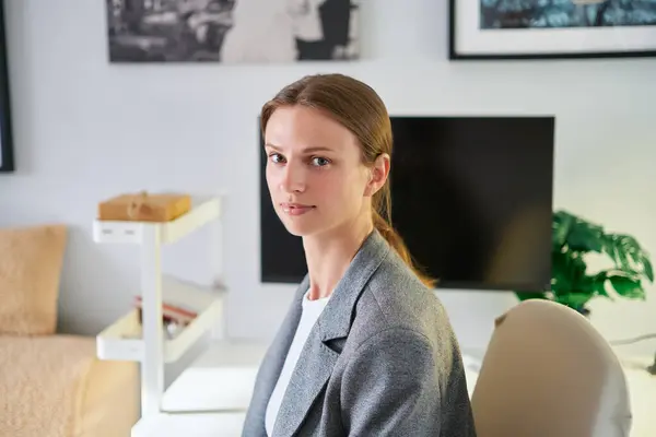 stock image Young female in the glasses and grey suit smiling in the office background. Hr or CEO woman, layer, maybe real estate. High quality photo