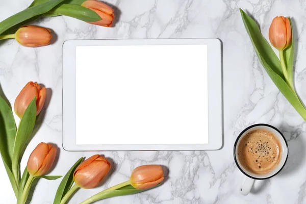 Tablet PC with beautiful tulips and coffee cup