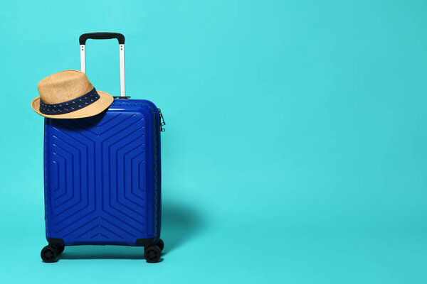 Blue trolley travel bag with hat