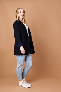 Portrait of beautiful blond woman on a beige background