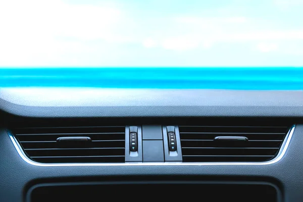 Modern car air vent front look against blue sky. Template for automotive accessories with air vent mounting.
