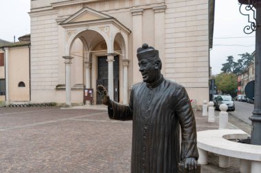 Brescello, Italy (8th November 2024) - The statue representing the movie character of Don Camillo in front of the church of the town clipart