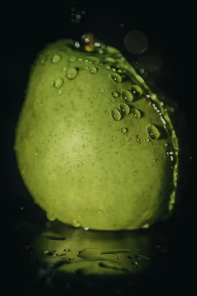 Image of a ripe pear with water droplets