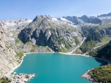 Karların arkasında dağlar olan göl.