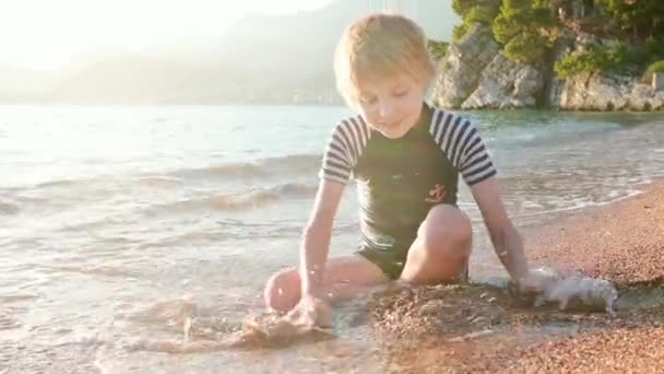 Happy Child Playing Sand Stones Sitting Seashore Joyful Boy Have — Stock Video
