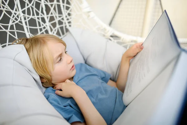 Preteen Boy Enthusiastically Reading Book Having Fun Sitting Comfortable Chair — Stock Photo, Image