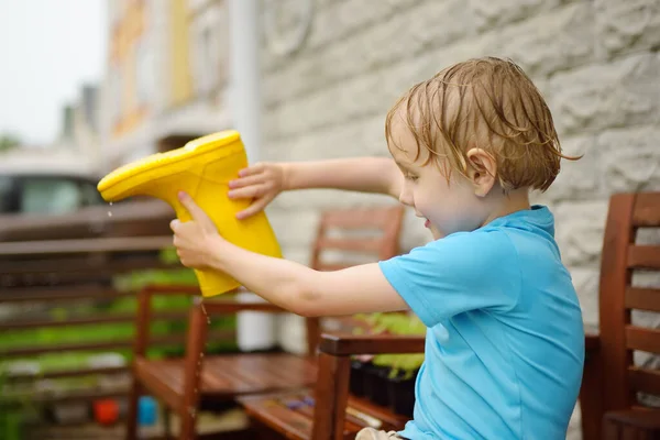 Thoroughly Soaked Preschooler Boy Pours Water Out Yellow Rubber Boot — Stock Photo, Image