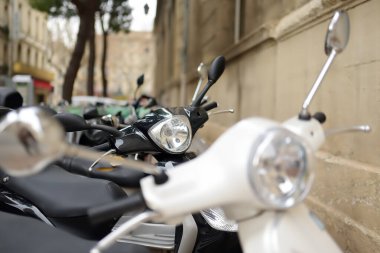 Motosiklet, mobiletler şehir yolunda park halinde. Eski Avrupa şehirlerinde bir park araçları sorunu var. Dar sokakları olan eski kasabalarda toplu taşıma tercih edilir..