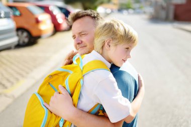 Little boy says goodbye and hugging to his father before going to school. Dad brought his son by car. Quality education for children. Child is a first day of school. Kids fear. clipart