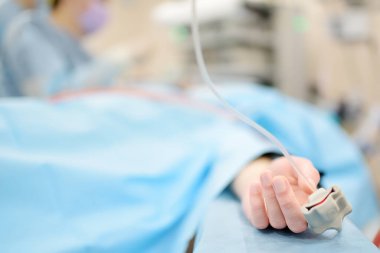 Klinikteki ameliyathanede ameliyat sırasında oksijeni parmak ucu nabız oksimetresiyle kontrol ediyorum. Oksijen doygunluğu. Ameliyat sırasında hastanın durumunun izlenmesi.