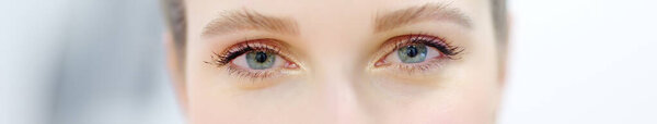 Banner with eyes of young woman. Close up cropped shot of young woman face with beautiful eyes. Good vision and eye care. Contact lenses. Female beauty.
