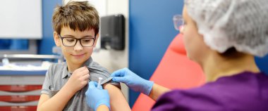 A boy is being vaccinated. A child is given a vaccine during an epidemic or outbreak of a disease. A kid during routine vaccination. Banner clipart