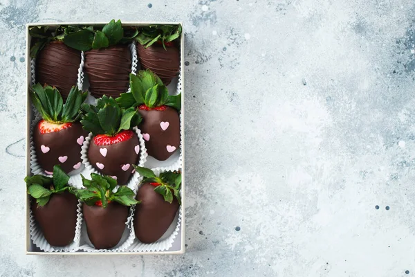 Gourmet chocolate covered strawberries on the light background. Delicious strawberries in a box for Valentines Day.