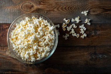 Ahşap arka planda patlamış mısır. Yemek ve atıştırmalık kavramları. En düşük görünüm modeli. Kopyalama alanı olan üst görünüm