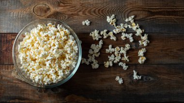 Ahşap arka planda patlamış mısır. Yemek ve atıştırmalık kavramları. En düşük görünüm modeli. Kopyalama alanı olan üst görünüm