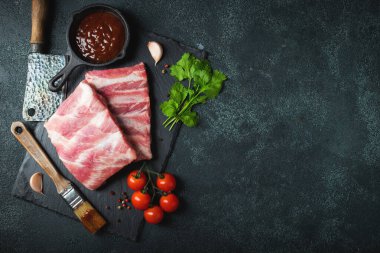 Çiğ et. Sırtından çiğ domuz kaburgası ve siyah bir arka planda et. arkaplan resmi, boşluk metni kopyala