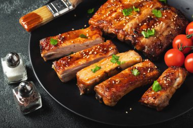 Barbekü soslu bir tabakta servis edilen sıcak ızgara pirzola. Üst Manzara. Boşluğu kopyala.