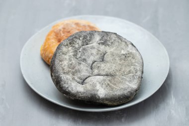 healthy small bread with carob and spices on ceramic dish