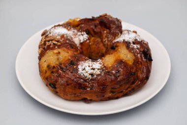 typical portuguese fruit cake Bolo rainha on white plate