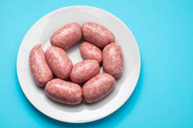 rolled botifarra, a pork meat sausage typical of Catalonia, Spain, in a plastic dish
