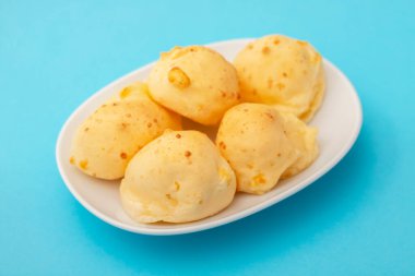 Brazilian snack pao de queijo cheese bread on white small dish