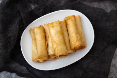 Spring Roll also known as Egg Roll on white small dish