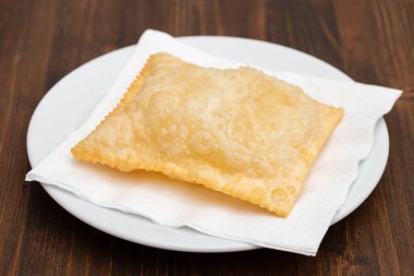 typical brazilian fried pastry on white small plate