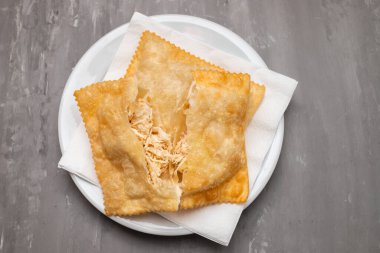 typical brazilian fried pastry on white small plate
