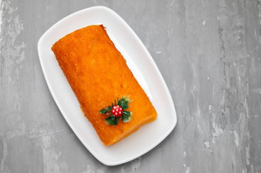 Typical portuguese orange cake on white dish on ceramic